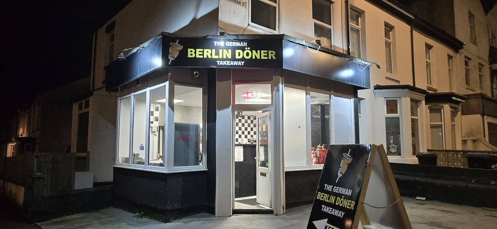 The German Berlin Doner takeaway shopfront on Buchanan Street, Blackpool, lit up at night